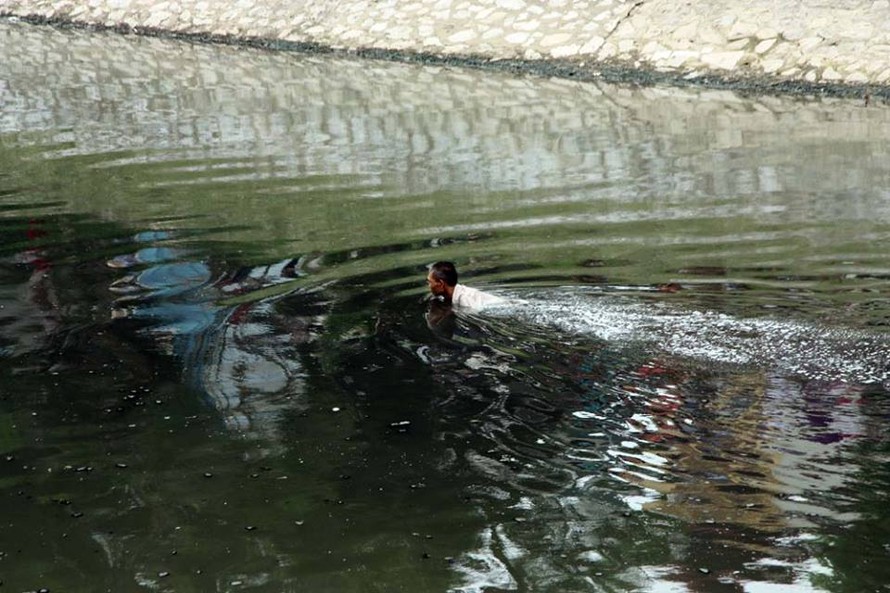 Người đàn ông bơi dưới sông Tô Lịch.