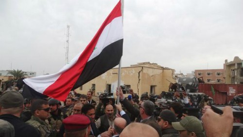 Thủ tướng Iraq cắm cờ lên tòa nhà chính phủ ở Ramadi, đánh dấu chiến thắng lớn trước IS. Ảnh: Reuters.