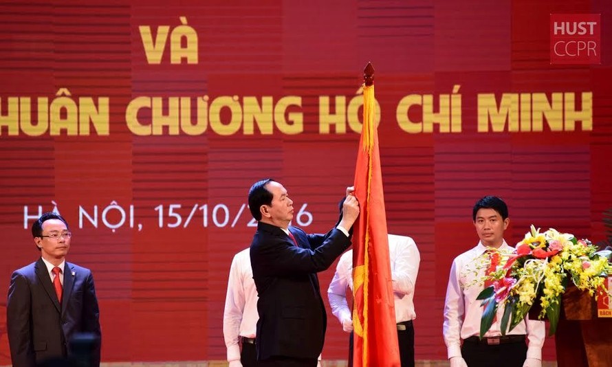 Chủ tịch nước Trần Đại Quang gắn Huân chương Hồ Chí Minh lên lá cờ truyền thống của ĐHBK Hà Nội.