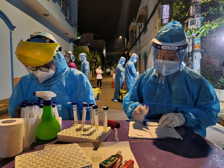 Nhân viên y tế lấy mẫu xét nghiệm trong khu vực phong tỏa khu dân cư Nam Long (ảnh: HCDC)