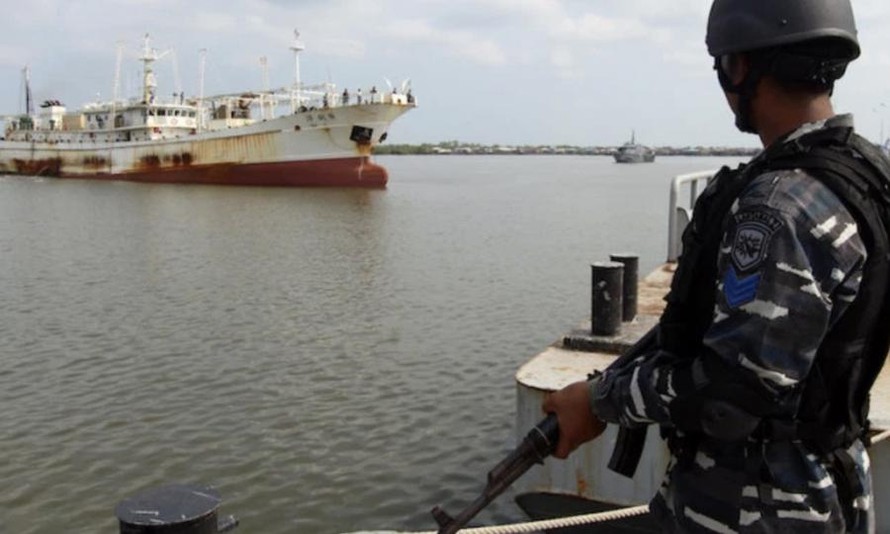 Một lính hải quân Indonesia đứng trước tàu cá “Hua Li-8” của Trung Quốc bị Indonesia bắt giữ năm 2016