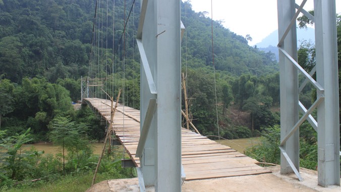 Cầu treo xã Trung Xuân, huyện Quan Sơn (Thanh Hóa) đang bị nhiều lỗi kỹ thuật, chưa xây dựng xong, nhưng người dân vẫn qua lại trên cầu. Ảnh: Hoàng Lam