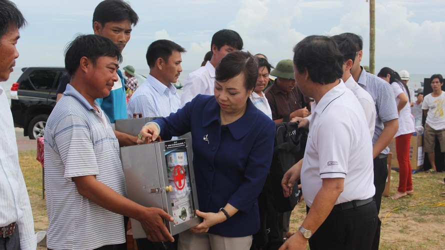 Bộ trưởng Nguyễn Thị Kim Tiến trao tủ thuốc cho ngư dân xã Cẩm Nhượng. 