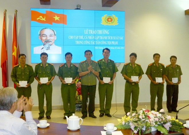 Đại tá Nguyễn Hữu Trí (thứ tư từ trái sang), Phó Giám đốc công an tỉnh Tiền Giang trao khen thưởng cho tập thể cán bộ có thành tích xuất sắc trong công tác tấn công tội phạm dịp Tết Nguyên đán 2014