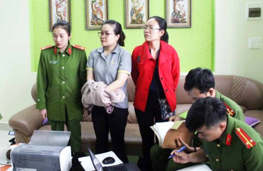 Nguyễn Thị Huyền Trang áo xám) bị bắt tạm giam.
