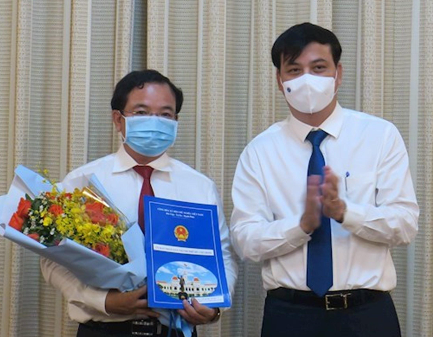 Ông Lê Quốc Tuấn (trái) nhận quyết định từ Phó Chủ tịch UBND TPHCM Lê Hòa Bình