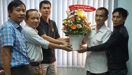 Ông Huỳnh Văn Nén (áo trắng ôm lẵng hoa) cùng con trai Huỳnh Thành Lượng đến Cơ quan đại diện báo Tiền Phong tại Thành phố Hồ Chí Minh để cảm ơn, ngày 4/11/2015