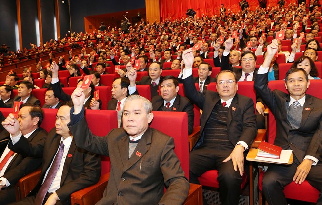 Các đại biểu, biểu quyết thông qua Nghị quyết Đại hội XII Đảng Cộng sản Việt Nam. Ảnh: Hồng Vĩnh.