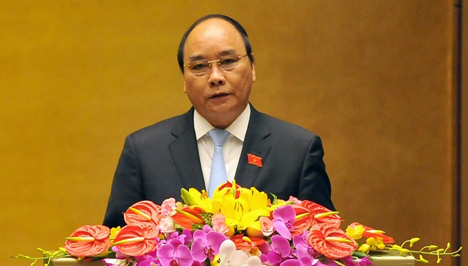 Phó Thủ tướng Nguyễn Xuân Phúc báo cáo trước Quốc hội về kết quả phát triển kinh tế xã hội giai đoạn 2011 - 2015, ngày 21/3. Ảnh: Như Ý.