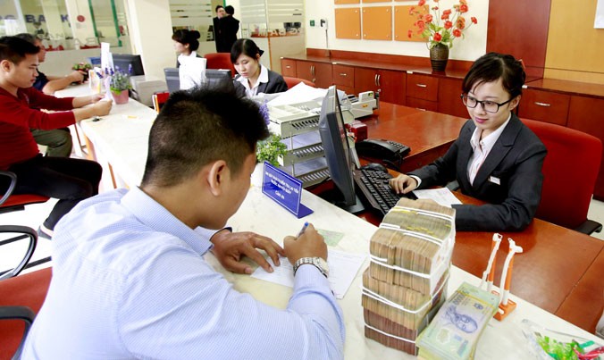 Chậm tái cơ cấu ngân hàng và xử lý nợ xấu sẽ ảnh hưởng đến phát triển kinh tế của Việt Nam. Ảnh: Như Ý.
