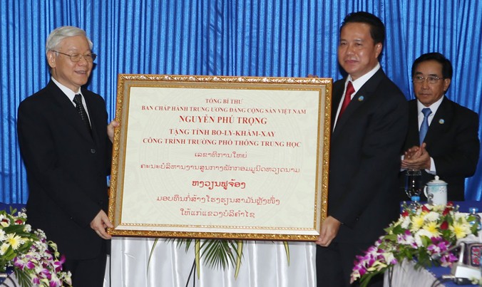 Tổng Bí thư Nguyễn Phú Trọng trao tặng tượng trưng công trình trường phổ thông trung học cho tỉnh Bolykhămxay. Ảnh: TTXVN.