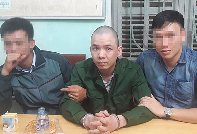 Nguyễn Văn Tình sau khi bị cảnh sát bắt giữ.