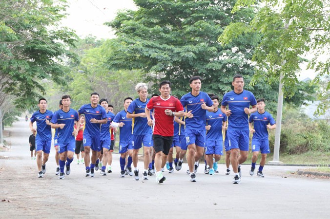 Các tuyển thủ Olympic Việt Nam phải tập tạm trên con đường bê tông trong khuôn viên một nhà máy gần khách sạn. Ảnh: HỮU PHẠM.