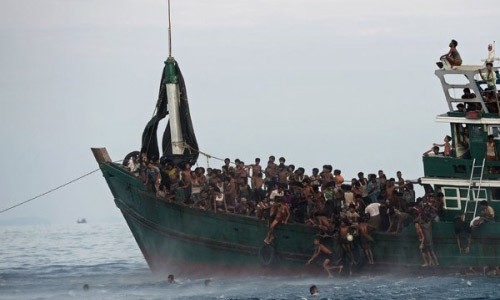 Người di cư Rohingya bơi ra để nhận đồ ăn cứu trợ trực thăng quân đội Thái Lan thả xuống biển Andaman hôm 14/5