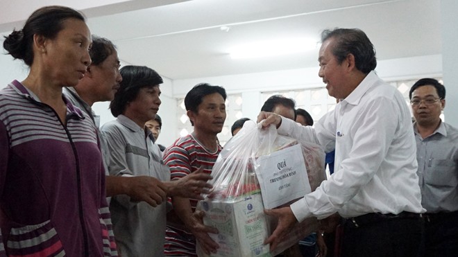 Phó Thủ tướng Thường trực Trương Hòa Bình tặng quà người dân bị nạn trong vụ hỏa hoạn.