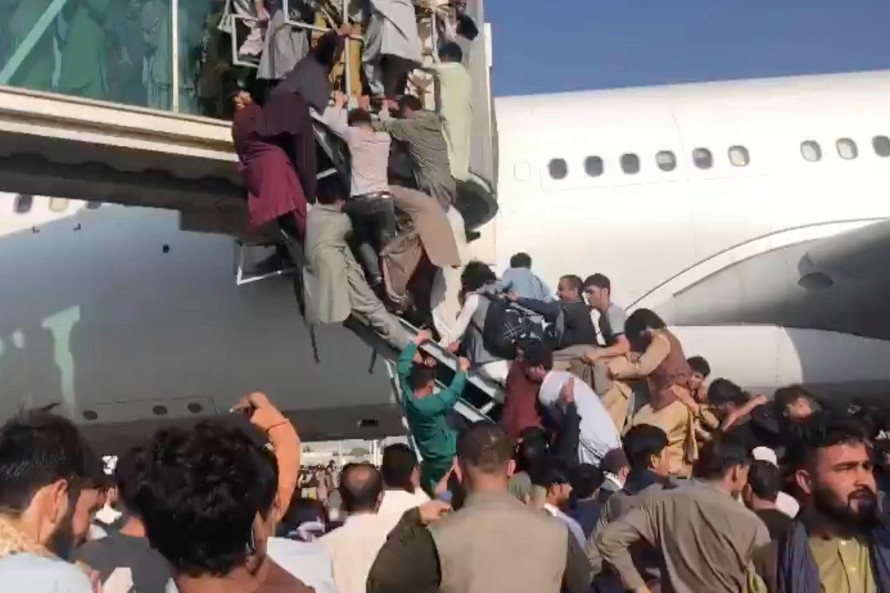 Người dân Afghanistan chen lấn trèo lên máy bay để rời khỏi Kabul ngày 16/8. Ảnh: BBC