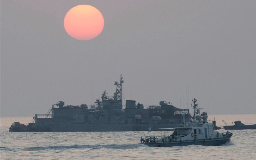 Một con tàu đi ngang qua căn cứ nổi của hải quân Hàn Quốc khi mặt trời mọc gần đảo Yeonpyeong. Ảnh: AP 