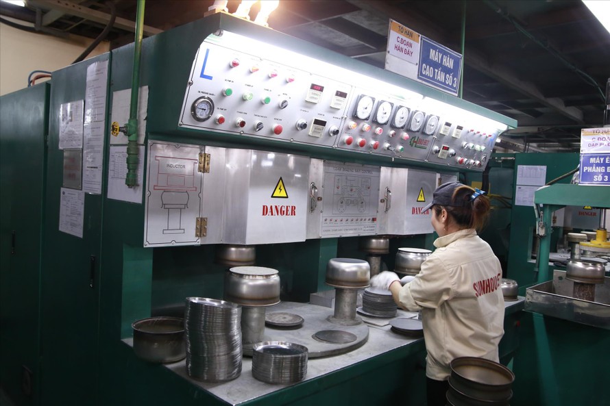 Công nhân nhà máy Sunhouse ở Quốc Oai (Hà Nội) đang sản xuất lòng nồi cơm điện
