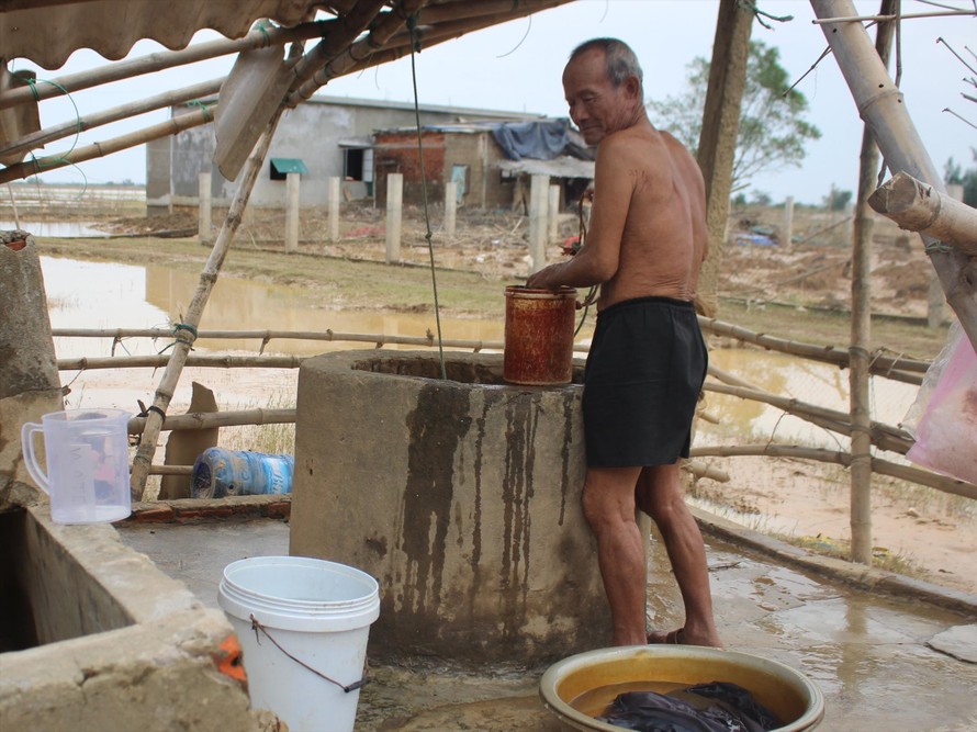 Ông Trương Văn Cường bên giếng nước bị nhiễm phèn và mặn 