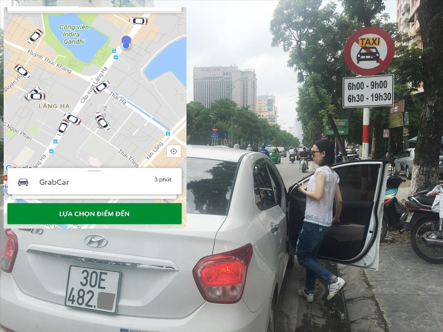Trên nhiều tuyến phố Hà Nội, taxi bị cấm nhưng xe Grab vẫn bắt khách hoạt động bình thường