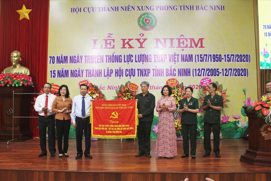 Ông Nguyễn Nhân Chiến, Bí thư Tỉnh ủy Bắc Ninh (bên trái) tặng bức trướng cho Hội cựu TNXP tỉnh Bắc Ninh