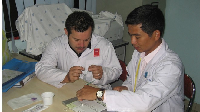Bác sĩ Trần Chí Cường đang hướng dẫn một bác sĩ nước ngoài về kỹ thuật can thiệp nội mạch thần kinh- ảnh L.N