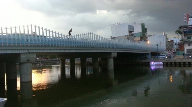 Chàng trai nhảy từ Cầu Kiệu xuống kênh Nhiêu Lộc. Ảnh: Phong Tran. 