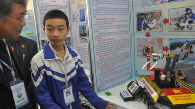 Nguyễn Văn Hoan bên mô hình rô-bốt cứu hộ đa năng tham dự cuộc thi sáng tạo khoa học kĩ thuật dành cho học sinh phổ thông năm 2015. (Ảnh: Văn Chung).