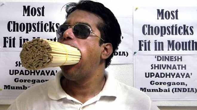 Thầy giáo Dinesh lập kỷ lục ngậm bó đũa trong miệng (Ảnh: Daily Mail)