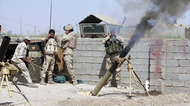 Binh sĩ Iraq bắn pháo trong lúc giao tranh với phiến quân Nhà nước Hồi giáo ở quận Karma, tỉnh Anbar, hôm 27/9. Ảnh: Reuters.