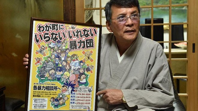 Satoru Takegaki, từng làm vệ sĩ cho cựu thủ lĩnh Yamaguchi-gumi, giơ tấm áp phích của chiến dịch chống mafia trong buổi phỏng vấn với AFP tại Himeji ngày 7/10. Ảnh: Kazuhiro Nogi.