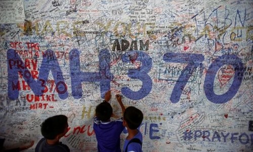 Bên ngoài sân bay quốc tế Kuala Lumpur, trẻ em viết những dòng cầu mong điều may mắn đến với các hành khách trên chuyến bay MH370 mất tích. Ảnh: Reuters. 