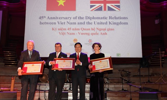 Phó Thủ tướng, Bộ trưởng Bộ Ngoại giao Phạm Bình Minh (thứ ba từ trái qua) trao Huy chương Hữu nghị cho bà Katrin Kandel, Giám đốc điều hành Facing the World