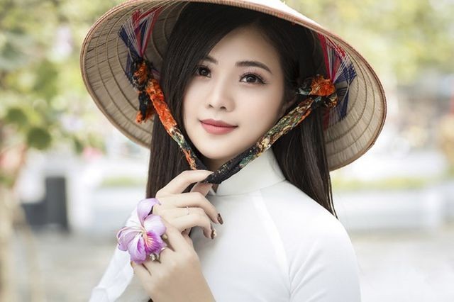 Thiếu nữ xinh đẹp đội nón lá khoe sắc với hoa ban