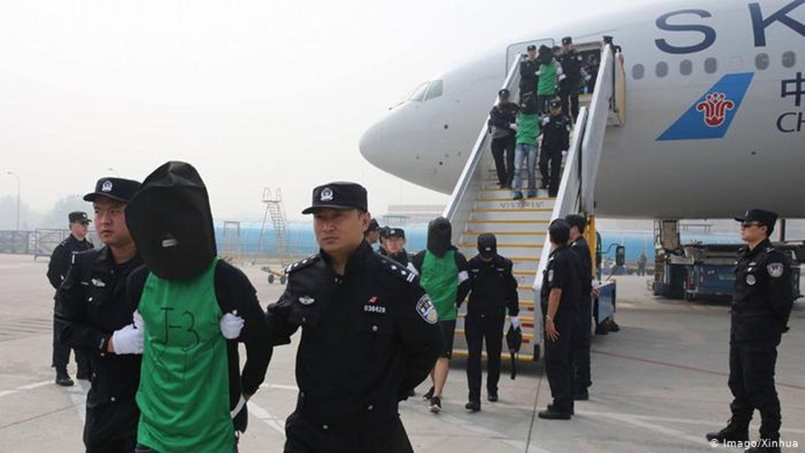 Các nghi phạm lừa đảo qua mạng bị dẫn giải về Trung Quốc.