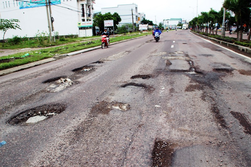 Mặt đường Quốc lộ 1 qua Bình Định hư hỏng nặng, nhà đầu tư chậm sửa chữa, nên bị dừng thu phí. Ảnh: SGGP.
