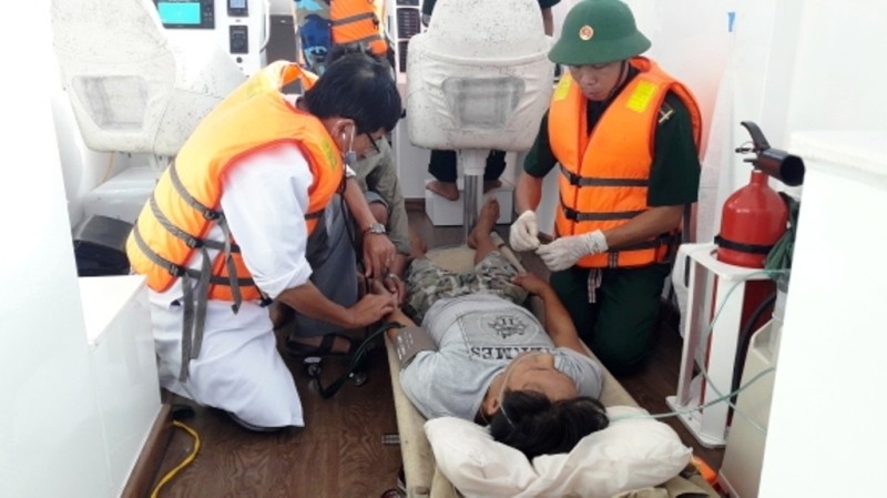 Bộ đội Biên phòng và nhân viên y tế cấp cứu ngư dân gặp nạn ngay trên biển. Ảnh: NGỌC BÌNH