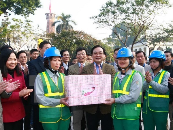 Bí thư Thành ủy Hoàng Trung Hải tặng quà Tết cho công nhân môi trường của Tổ Hoàng Diệu (Xí nghiệp Môi trường Đô thị số 1). (Ảnh: Doãn Tấn/TTXVN)
