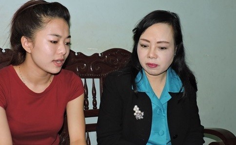 Bộ trưởng Bộ Y tế Nguyễn Thị Kim Tiến (bên phải) thăm hỏi gia đình em Vi.