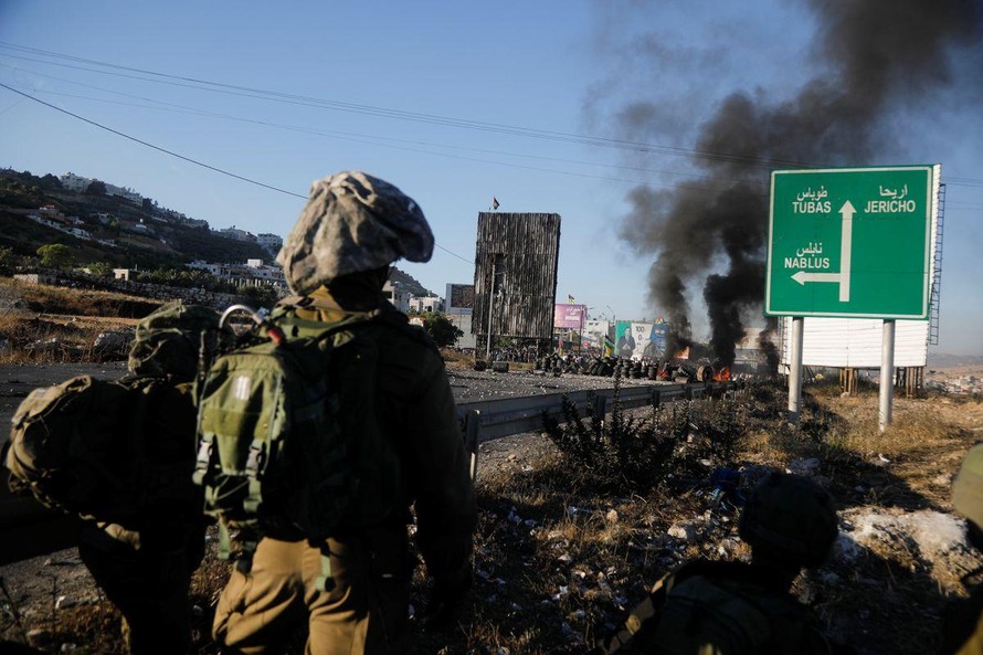 Người Palestine ở Bờ Tây đốt lốp xe phản đối chiến dịch tấn công Dải Gaza của Israel. Ảnh: Reuters