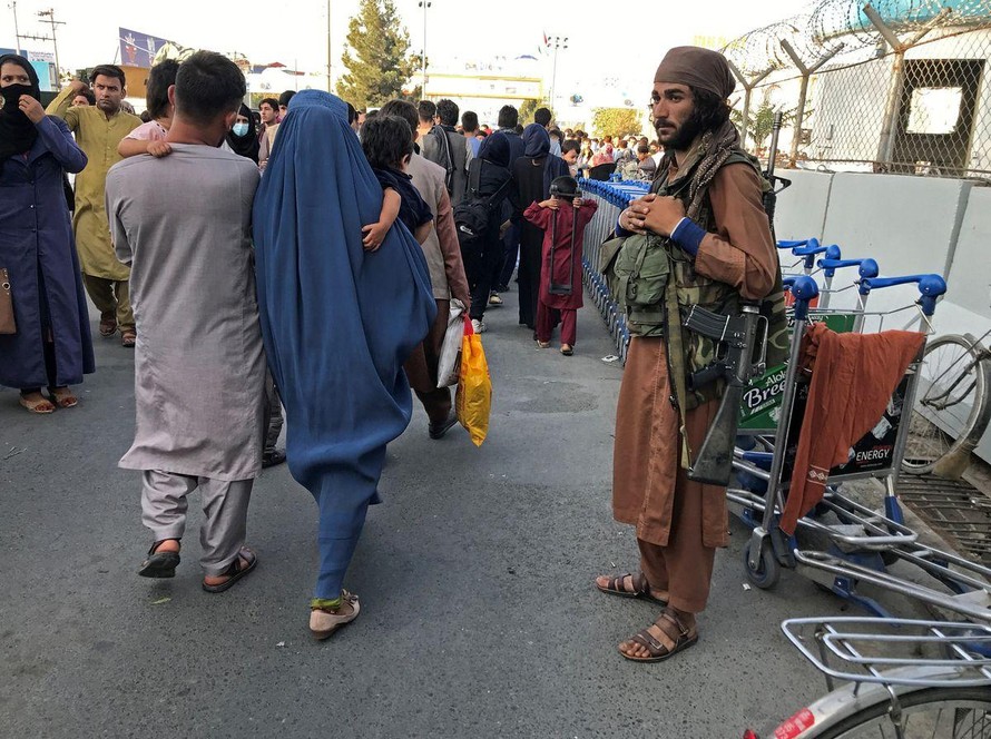 Tay súng Taliban đứng gác bên ngoài sân bay Kabul. Ảnh: Reuters
