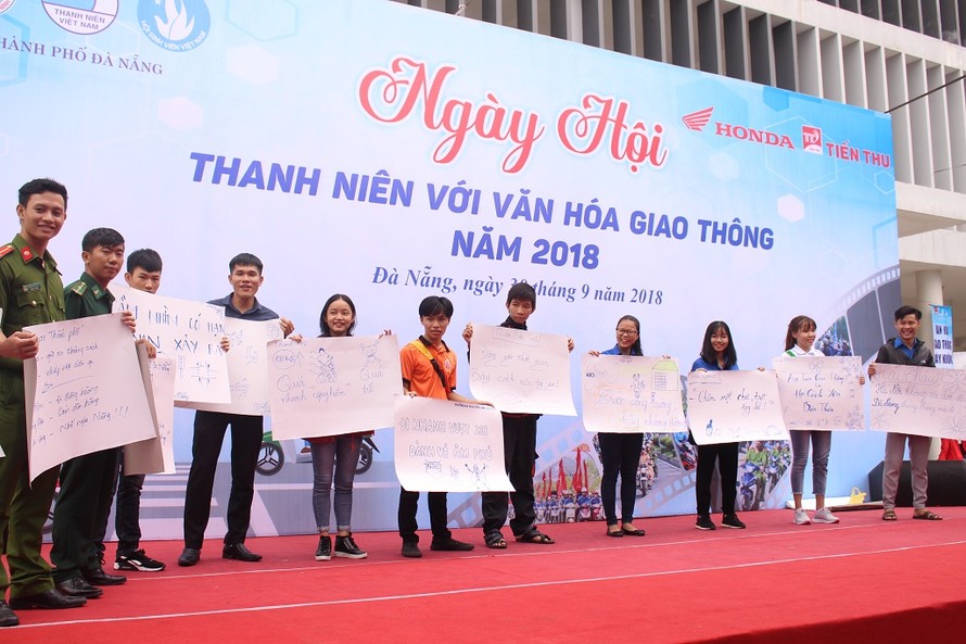 Các bạn ĐVTN hào hứng tham gia phần thi sáng tác slogan tuyên truyền an toàn giao thông. Ảnh: Giang Thanh