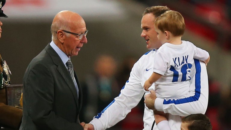 Rooney nhận sự chúc mừng từ Sir Bobby Charlton.