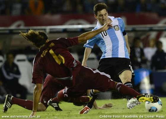 Messi vượt qua sự truy cản của một cầu thủ Venezuela.