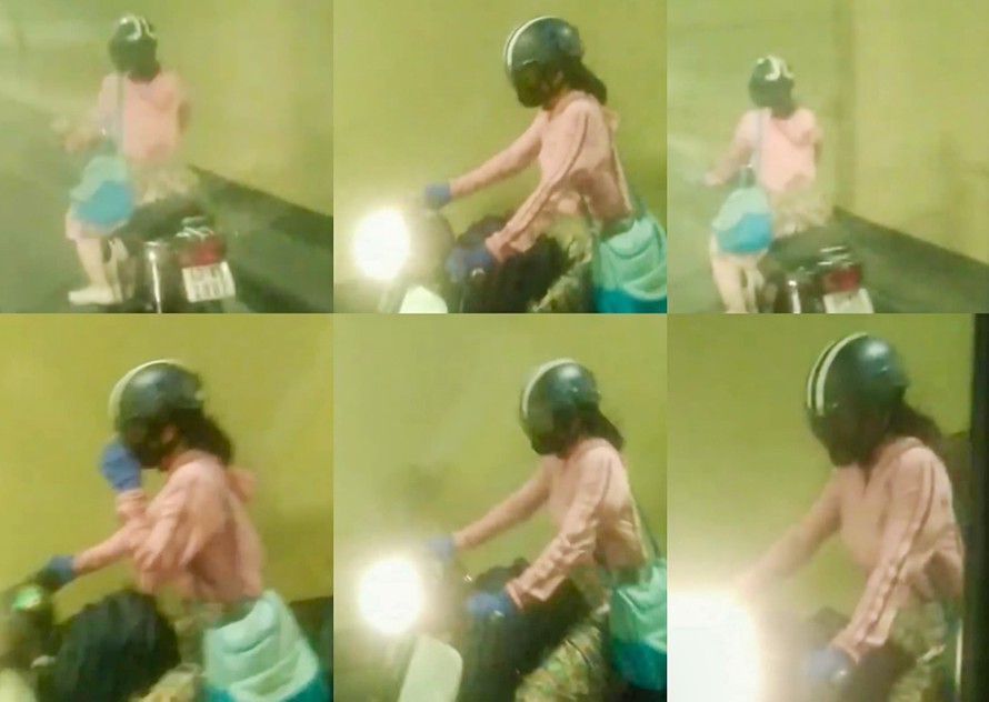 Cô gái trẻ điều khiển xe máy, vượt các chốt chặn để chạy xuyên hầm Hải Vân. Ảnh: chụp lại clip. 
