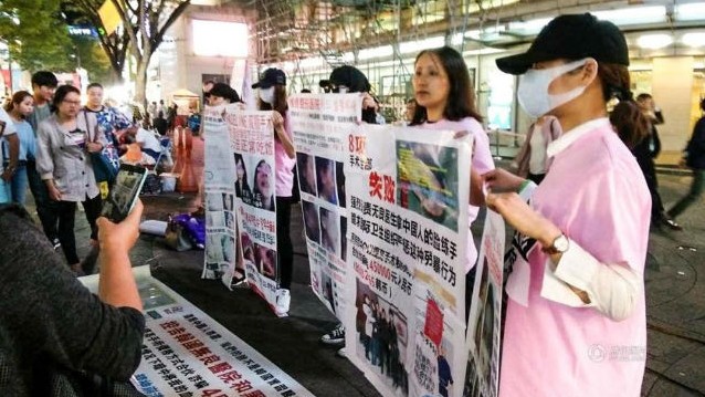Những cô gái cầm tờ poster về các vụ phẫu thuật thẩm mỹ thất bại, tố cáo các trung tâm môi giới và những bệnh viện vô trách nhiệm. 