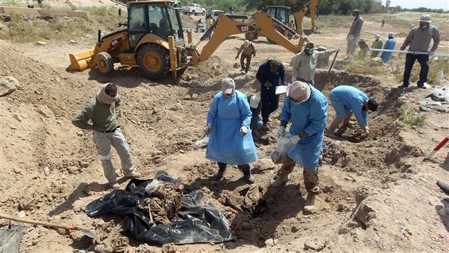 Lực lượng an ninh Iraq kiểm tra các hố chôn tại thành phố Tikrit hôm 12/4. Ảnh: Press TV