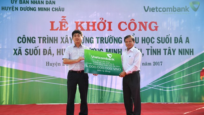 Chủ tịch HĐQT Vietcombank Nghiêm Xuân Thành trao biển tượng trưng số tiền tài trợ 4 tỷ đồng cho lãnh đạo địa phương