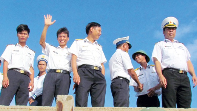 Trung úy Nguyễn Duy Chinh giơ tay chào tạm biệt khách thăm đảo Trường Sa