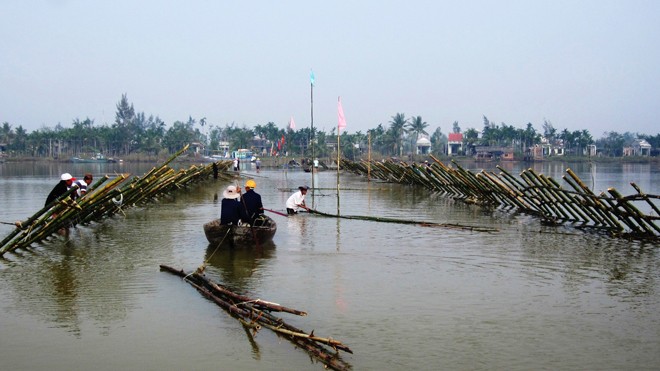 Người dân Đông Bình đóng kè ngăn sông trong những ngày đầu ra quân. Ảnh : Nguyễn Thành